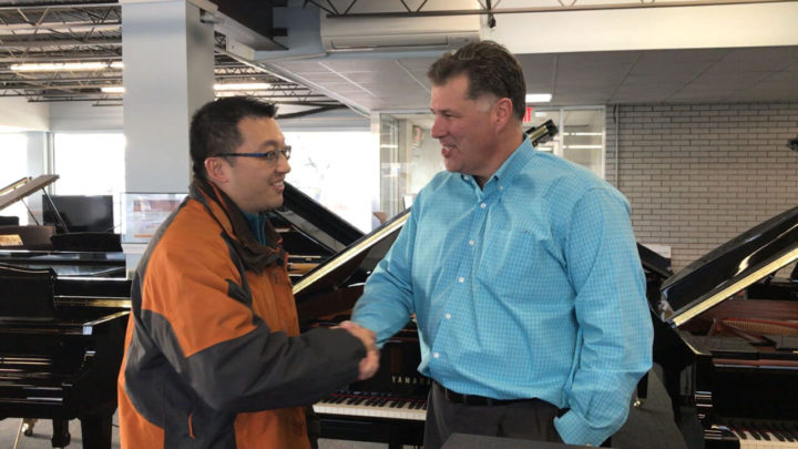 two men sharing memory in piano reunion