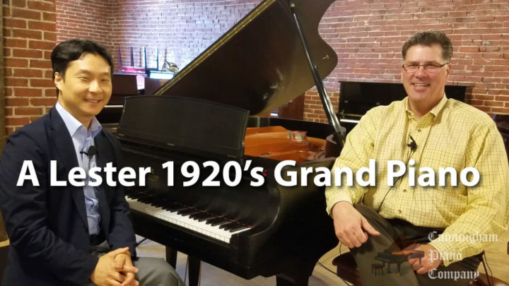 Two Men sitting next to Lester Grand Piano