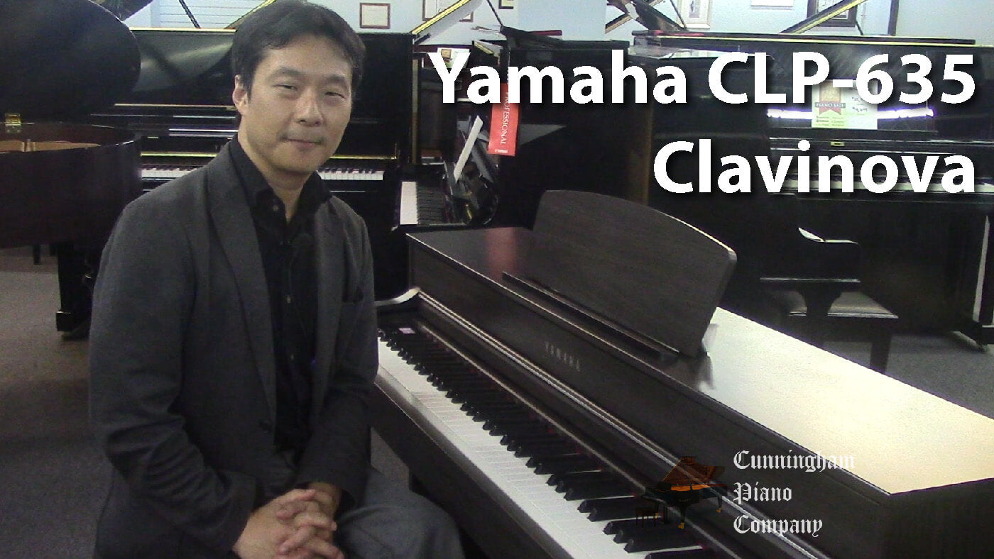 a men in black dress sitting with Yamaha CLP-635 Clavinova